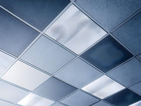 Decorative suspended ceiling with textured translucent panels and integrated lighting, used in upscale commercial or retail interior design