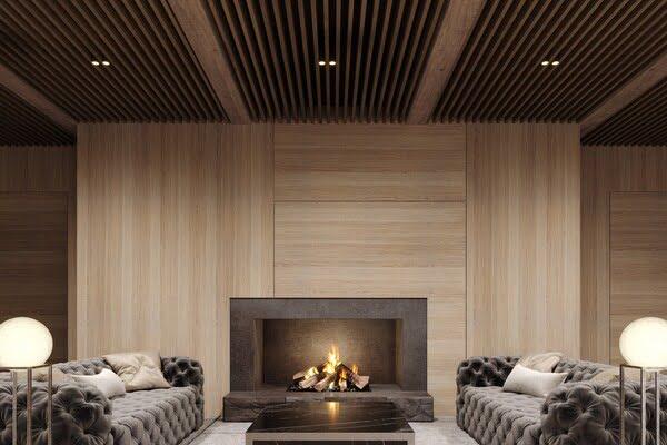 Modern luxury lounge with decorative wood wall panels and slatted ceiling design, featuring a cozy fireplace and tufted velvet sofas