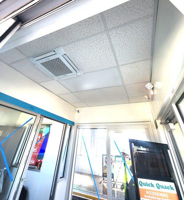 Ceiling tiles with AC unit and lighting in a commercial entryway