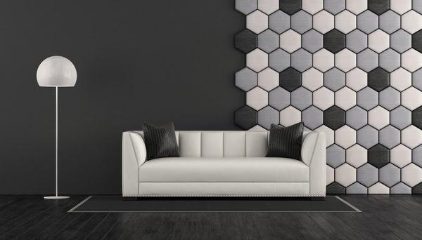 Modern living room with designer hexagon acoustic wall panels in grey tones, combining sound absorption with bold geometric wall design