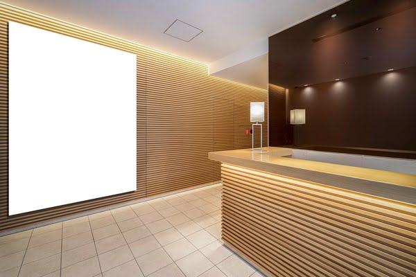 Reception area featuring horizontal wooden acoustic wall panels and integrated lighting for sound control and visual warmth