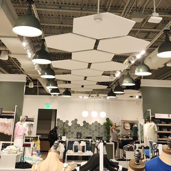 Floating hexagon ceiling panels in a retail clothing store