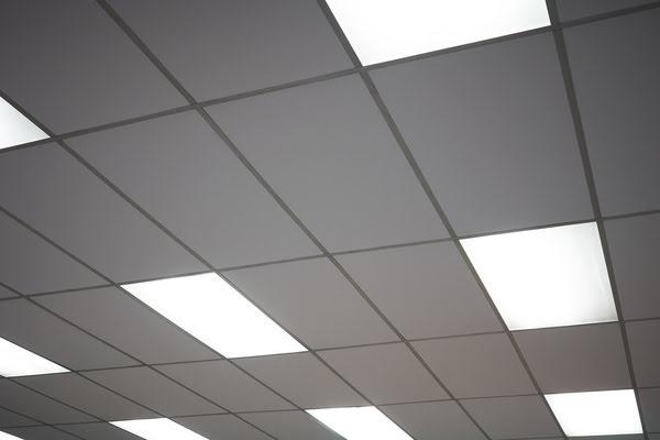 Suspended drop ceiling with rectangular acoustic tiles and integrated fluorescent light panels, commonly used in office and school ceiling installations