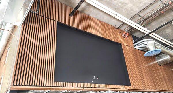 Decorative wooden wall panel installation in modern industrial interior